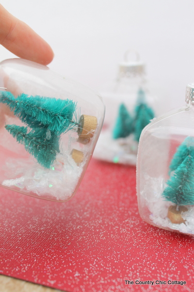 Kids Craft: Mini Snow Globe Ornaments -- click the picture to get the full instructions for making your own fun Christmas ornaments. shaking mini snow globe ornament