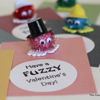 Homemade valentine card with pom-pom character and text overlay