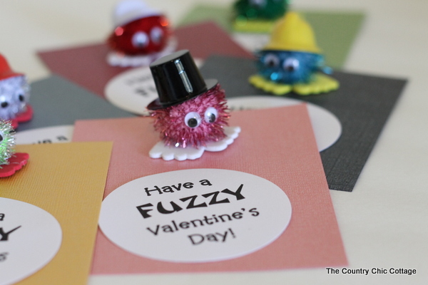 Homemade valentine card with pom-pom character and text overlay