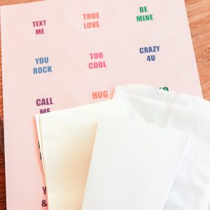 conversation heart stickers with white bags on a table
