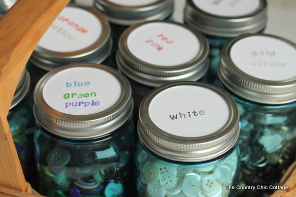 close view of colored mason jars for organizing buttons