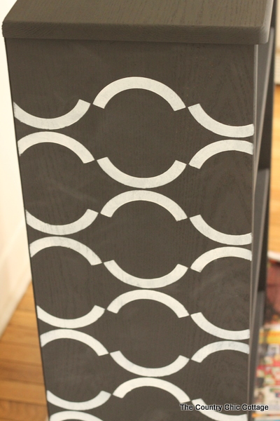 Stenciled bookcase -- a great idea for using new chalky finish paint to update an unfinished bookcase.