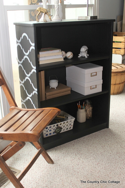 Stenciled bookcase -- a great idea for using new chalky finish paint to update an unfinished bookcase.