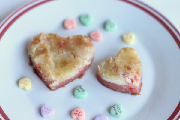 Strawberry Cream Cheese Gooey Cake -- perfect for serving heart shaped portions for Valentine's Day.