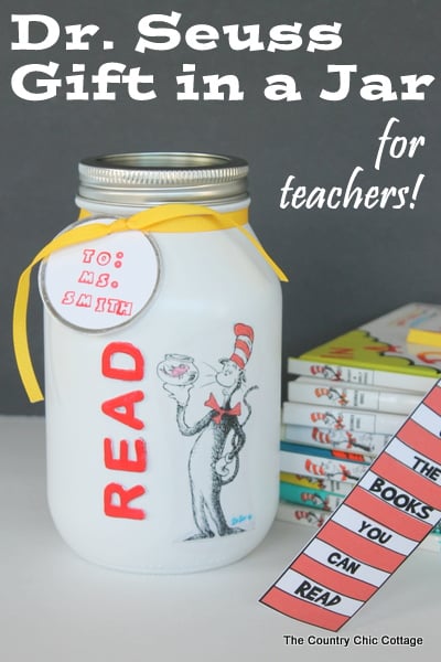 Dr. seuss gift in a jar next to stack of books and homemade bookmark.