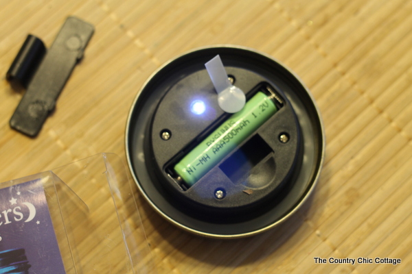 Solar Mason Jar Lights -- add tops to your mason jars and use solar power to light up the outdoors. removing the tag from the solar light so it can charge in sunlight
