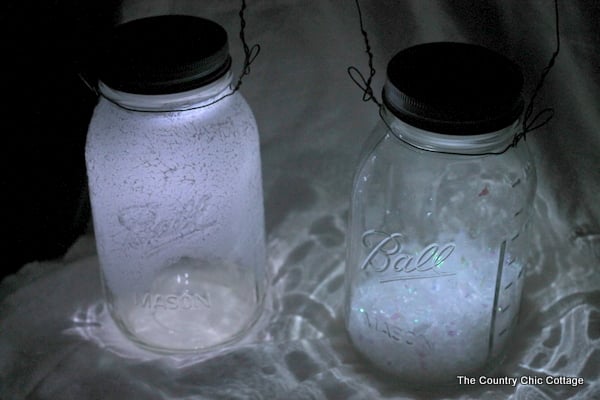 Solar Mason Jar Lights -- add tops to your mason jars and use solar power to light up the outdoors. glowing solar mason jar lights at night