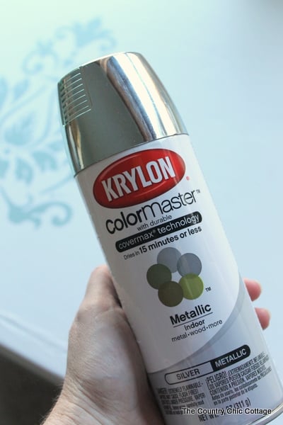 woman holding a bottle of Krylon spray paint