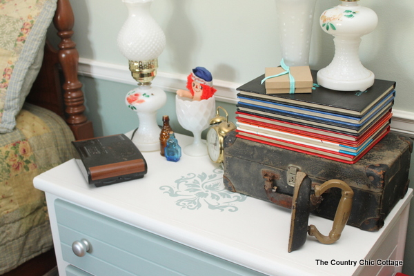 image of an assortment of items on top of a painted nightstand