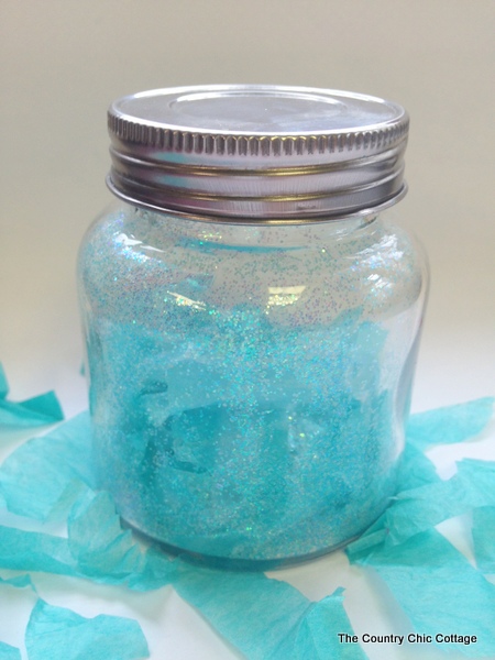 Blizzard in a jar craft inspired by Disney's Frozen. Make your own Disney's Frozen craft with these super simple instructions.