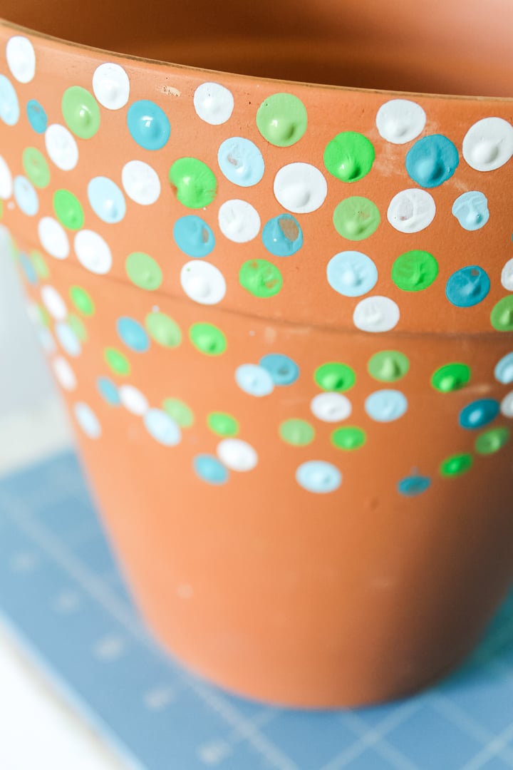 adding paint to an outdoor planter