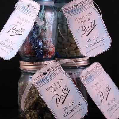 Four mason jars with wedding tags