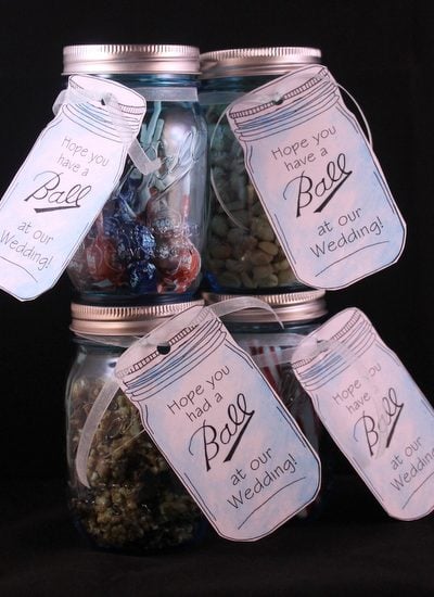 Four mason jar wedding favors with tags