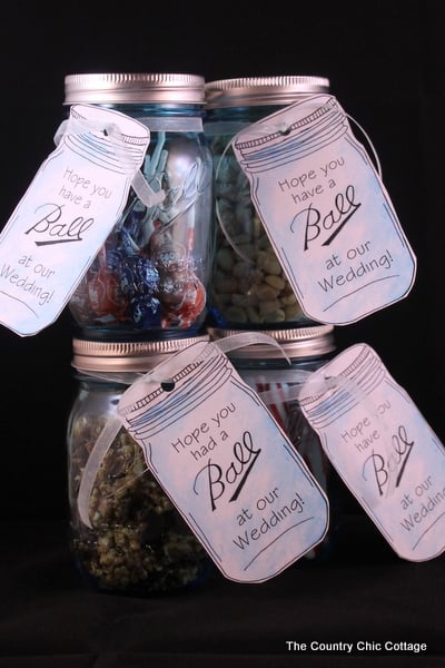 four mason jars with wedding tags