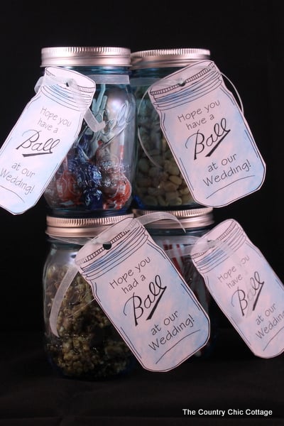 Mason Jar wedding favors with free printable tags -- love mason jars and these tags and they are available to print in a variety of "Ball" jar sayings! four mason jars with wedding tags