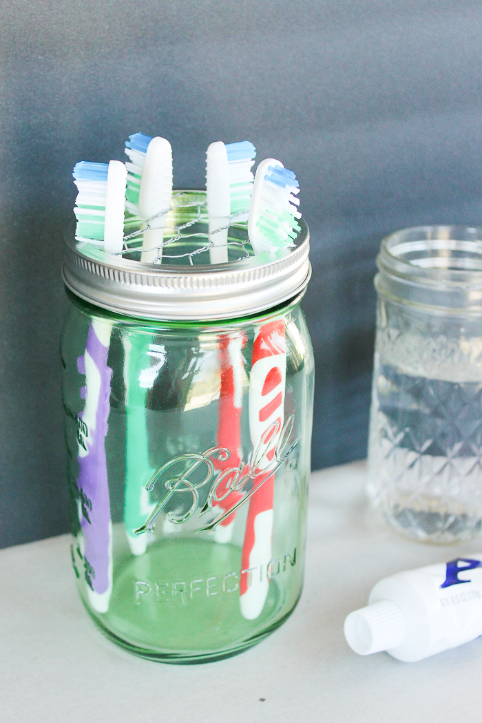 A mason jar toothbrush holder for a farmhouse style home