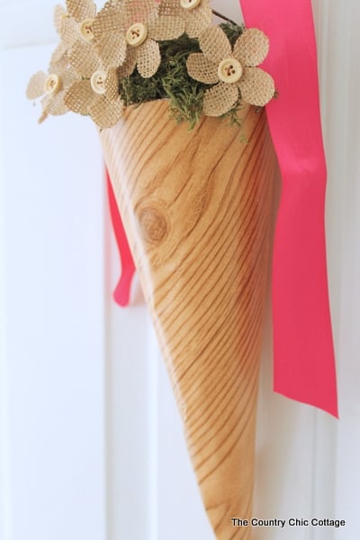 Spring Cone Wreath -- a fun alternative to a wreath for your front door. Spring Cone Wreath hanging on door