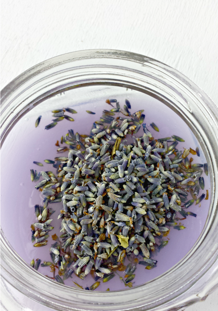 adding dried lavender to soap base for sugar scrub
