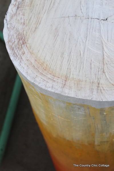 Painting the top of a log table.