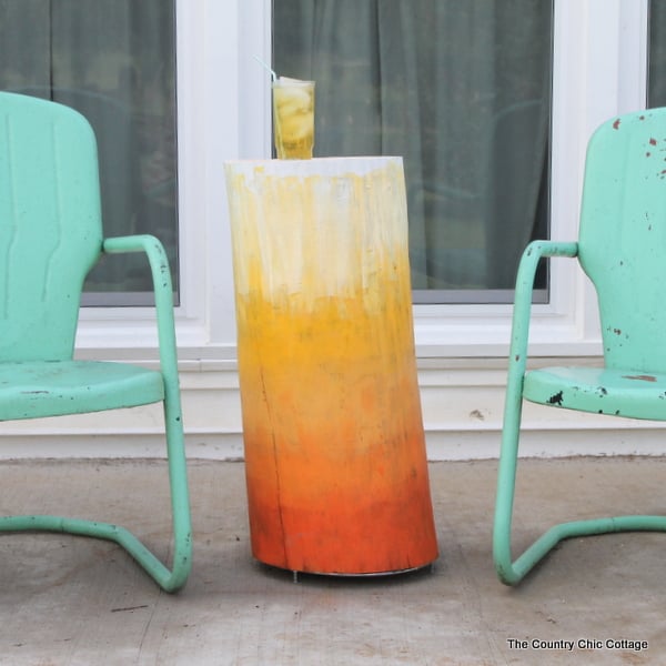 Orange gradient patio table made from a wood log.