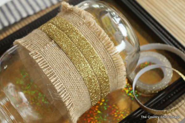 adding glitter tape around burlap on a mason jar