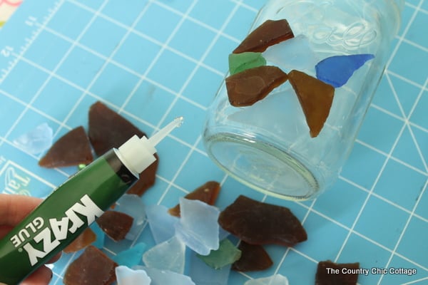 gluing sea glass to a mason jar with krazy glue