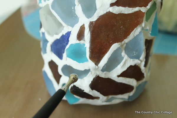 smoothing clay with a clay tool