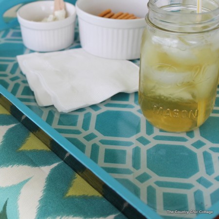 Make this Outdoor Serving Tray -- turn a thrift store tray into a fun accessory for your outdoor entertaining area with these instructions.