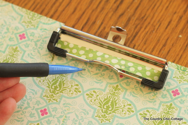 tracing pattern paper around a clipboard clip