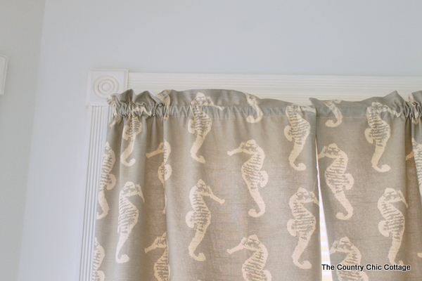 close up of extra fabric above the curtain rod