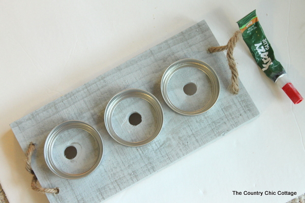 process image of mason jar bands glued to the wood base