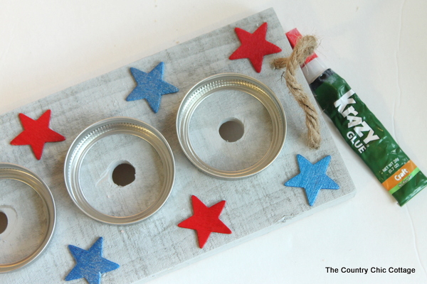 gluing painted stars to the wood base