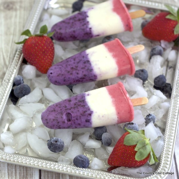 Red, White, and Blue Yogurt Pops -- a fun and healthy way to stay cool this summer.  Click to get the recipe.