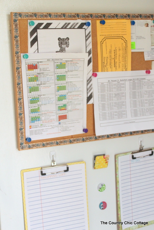 cork board and clipboards hanging on refrigerator