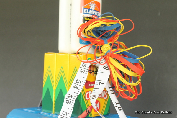 crayons with glue on top with a rubber band bow