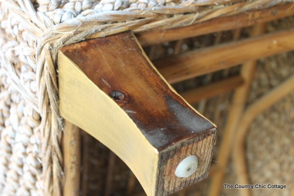 wooden legs on wicker bench