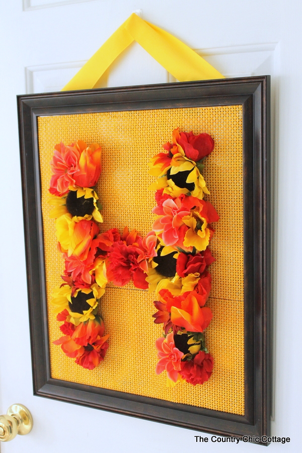 Floral Monogram Wreath -- supplies from Dollar General transform into a gorgeous one of a kind wreath. Get the full instructions for making your own here.