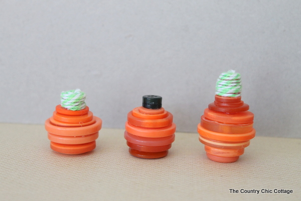 three pumpkin shaped button stacks