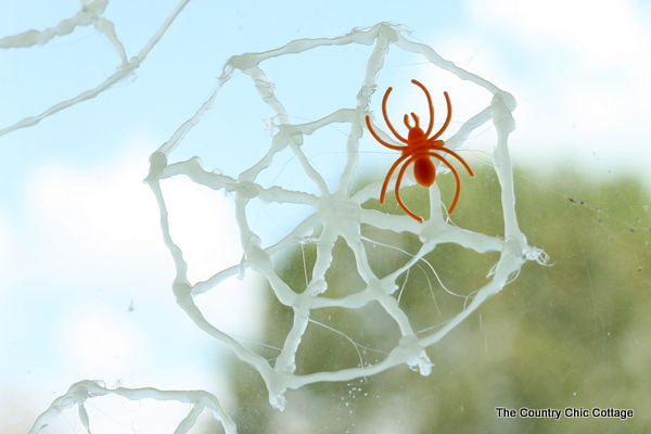 glow in the dark spider web window cling with orange spider