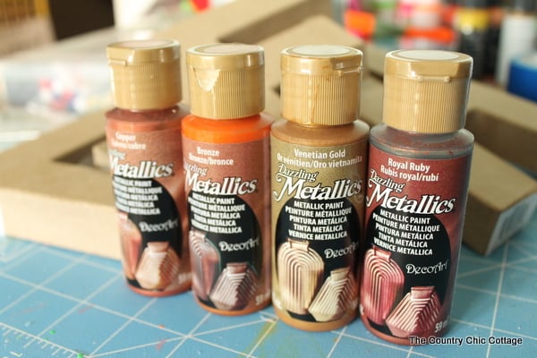 four bottles of DecoArt Dazzling Metallics line of acrylic paint