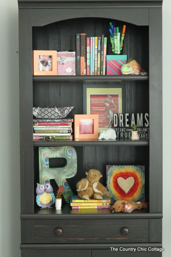 Style a Bookcase in 4 minutes or less -- tips and techniques on arranging items in a bookcase or any shelf!