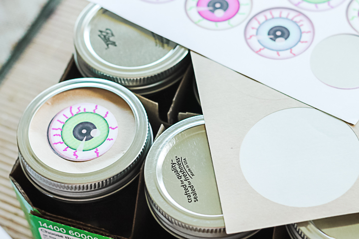 adding eyeball stickers to mason jars