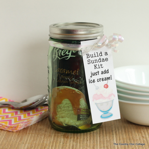 Build a Sundae Kit Gift in a Jar -- fill a mason jar with everything needed for a sundae but ice cream. Includes free printable tags!
