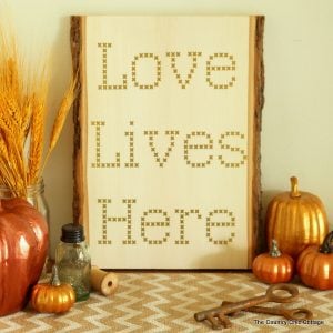 Make your own cross stitch sign on wood using vinyl and your Cricut Explore.