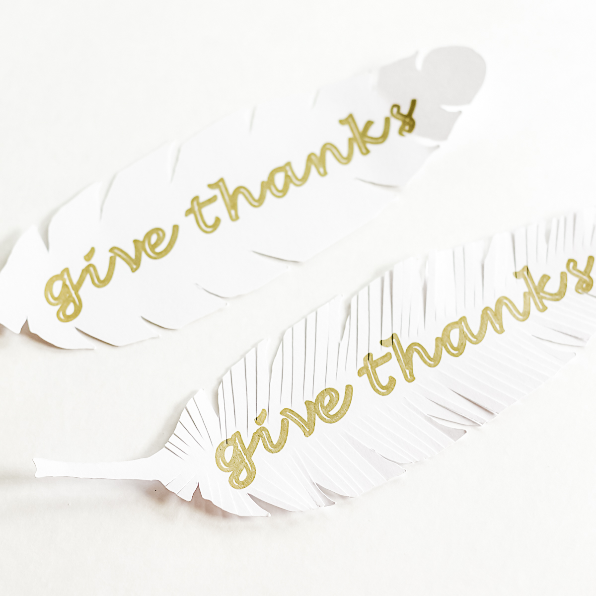 paper feathers with writing on them