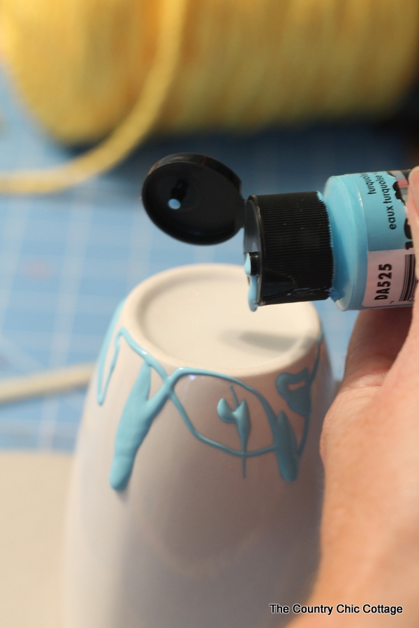 Dripping Turquoise paint on a white mug