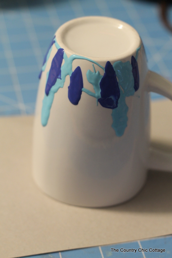 Cobalt and turquoise paint on a white coffee mug 