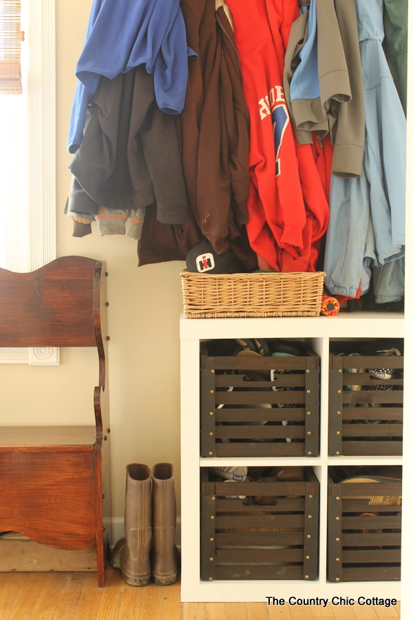 Farmhouse mudroom ideas, a cube organizer with wood crates inside of it