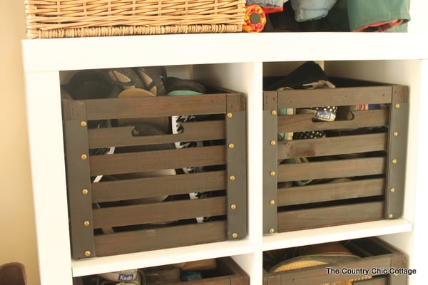 Wood crates with shoes inside of them in mudroom