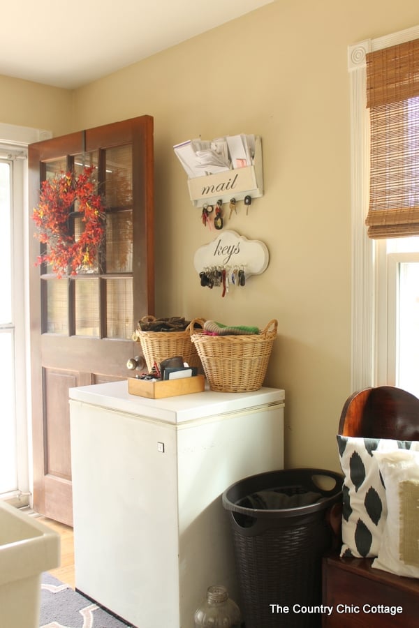 A deep freezer and baskets on top of it. 